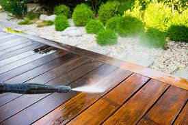 Pressure washing a deck.